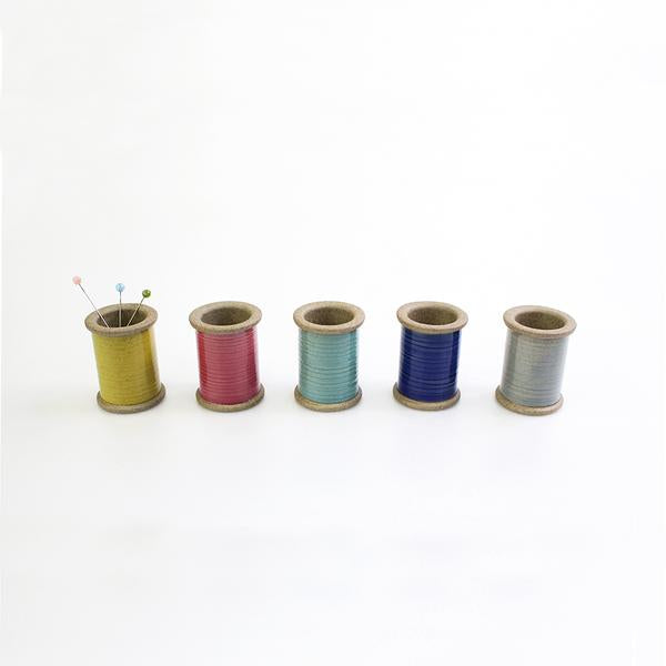 Cohana - Hasami Magnetic Pin Holder - Each pin holder is finished with a colourful glaze to resemble a real spool of thread. The pin holder's magnet holds metal objects securely both on the inside and the exterior