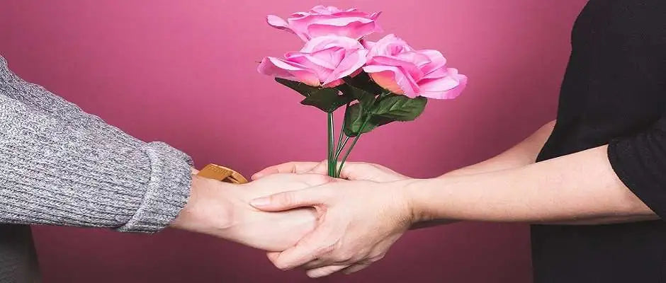 Mothers Day in the UK - Child give mother flowers to celebrate the day