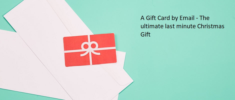 Red gift card with a white bow on a white envelope against a light green background, promoting an email gift card for Christmas.