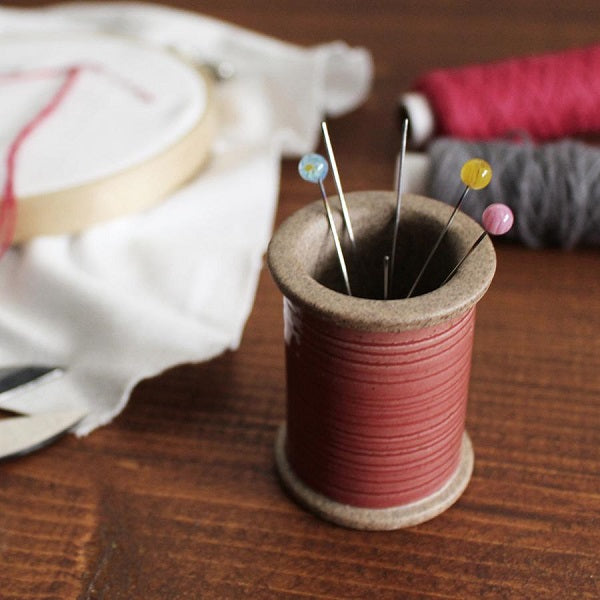 Cohana - Hasami Magnetic Pin Holder - Each pin holder is finished with a colourful glaze to resemble a real spool of thread. The pin holder's magnet holds metal objects securely both on the inside and the exterior .