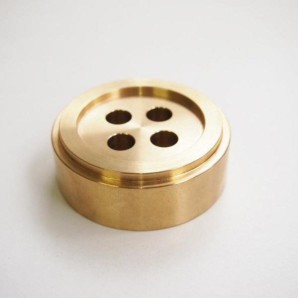 Cohana Brass Button Shaped Paperweight - Exquisitely designed with expert craftsmanship. The brass finish shimmers subtly in the light and adds an elegant feel to your space. Each paperweight can also be used as a pen holder for up to 4 pens.