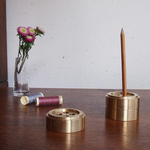 Cohana Brass Button Shaped Paperweight - Exquisitely designed with expert craftsmanship. The brass finish shimmers subtly in the light and adds an elegant feel to your space. Each paperweight can also be used as a cute pen holder for up to 4 pens.